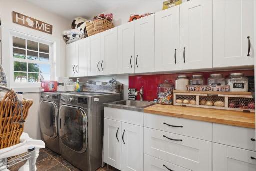 Just off the kitchen, this pantry offers laundry, additional storage and cupboards