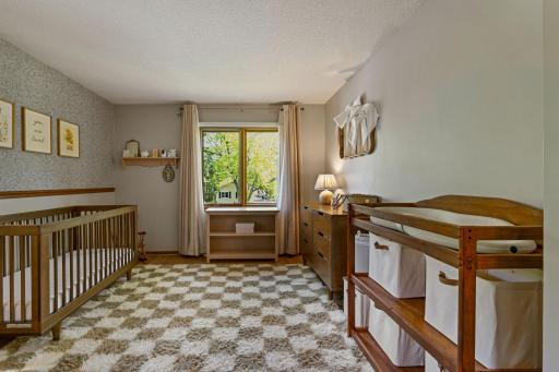 Second bedroom on upper level is spacious and light filled.