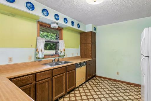 Kitchen features ample counter space, a double sink (with window and light).