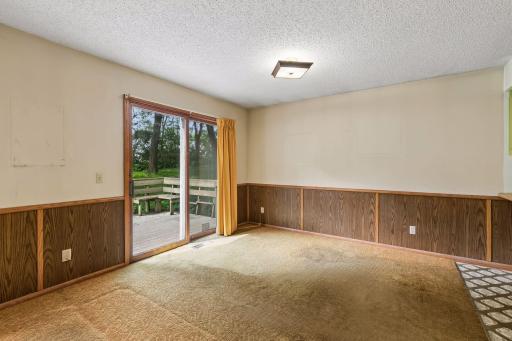 Dining room features a sliding door to the deck and an overhead light.