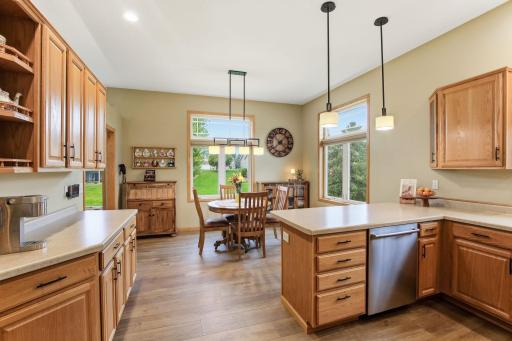 The Newer LVP Flooring Continues into the Kitchen & Dining Room. Plenty of Light on the Main Level with the Transom Windows.