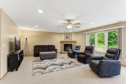 The Lower Level Walkout Family Room Features a Corner Gas Fireplace & Recessed Lights.