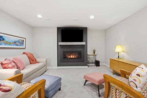 The finished lower level boasts an additional gathering room, 4th bedroom, 4th bathroom, and a storage/utility room.