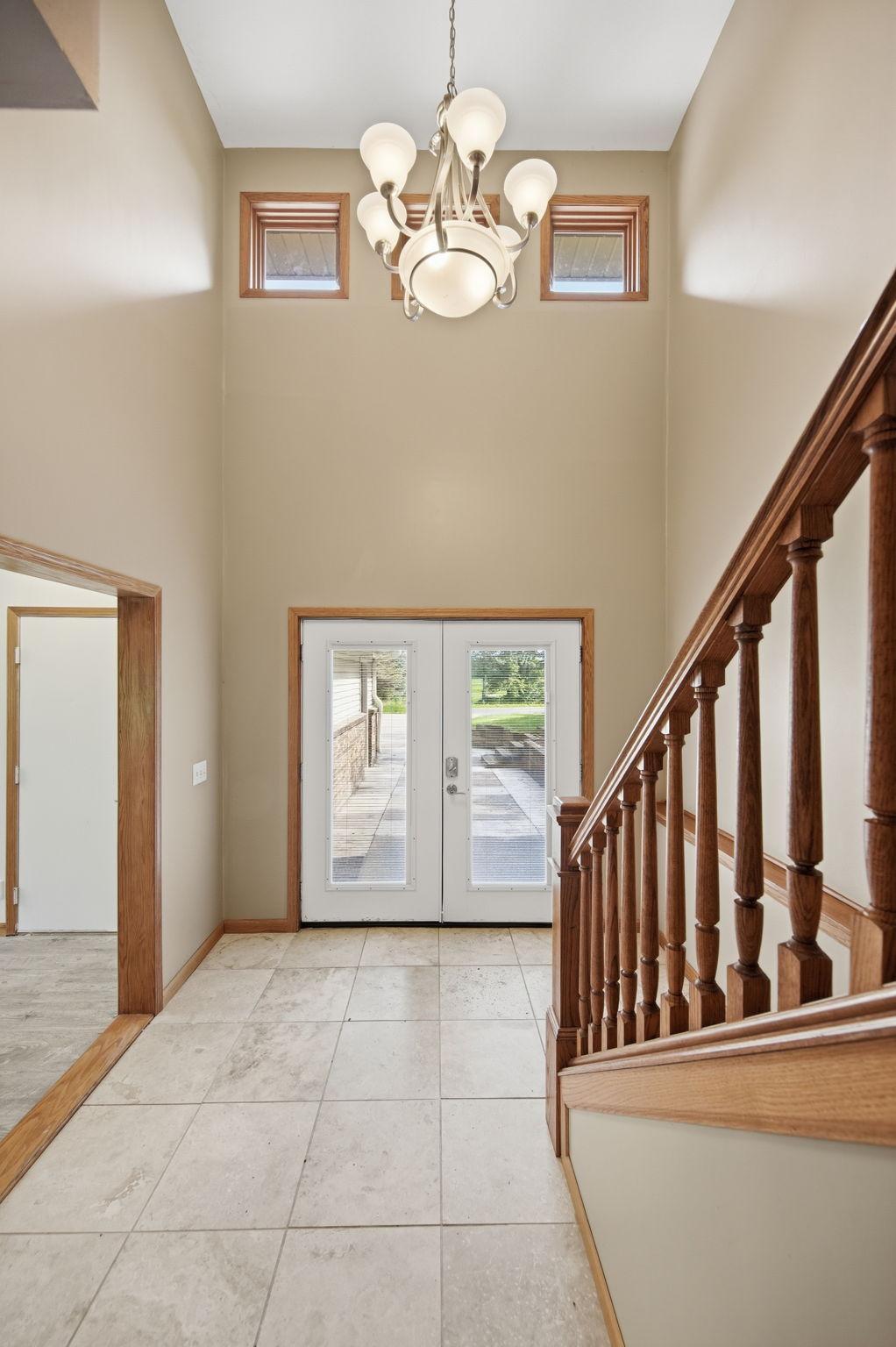 The entry into this home features a spacious foyer. Note: the door on the left in the photo leads to the garage.