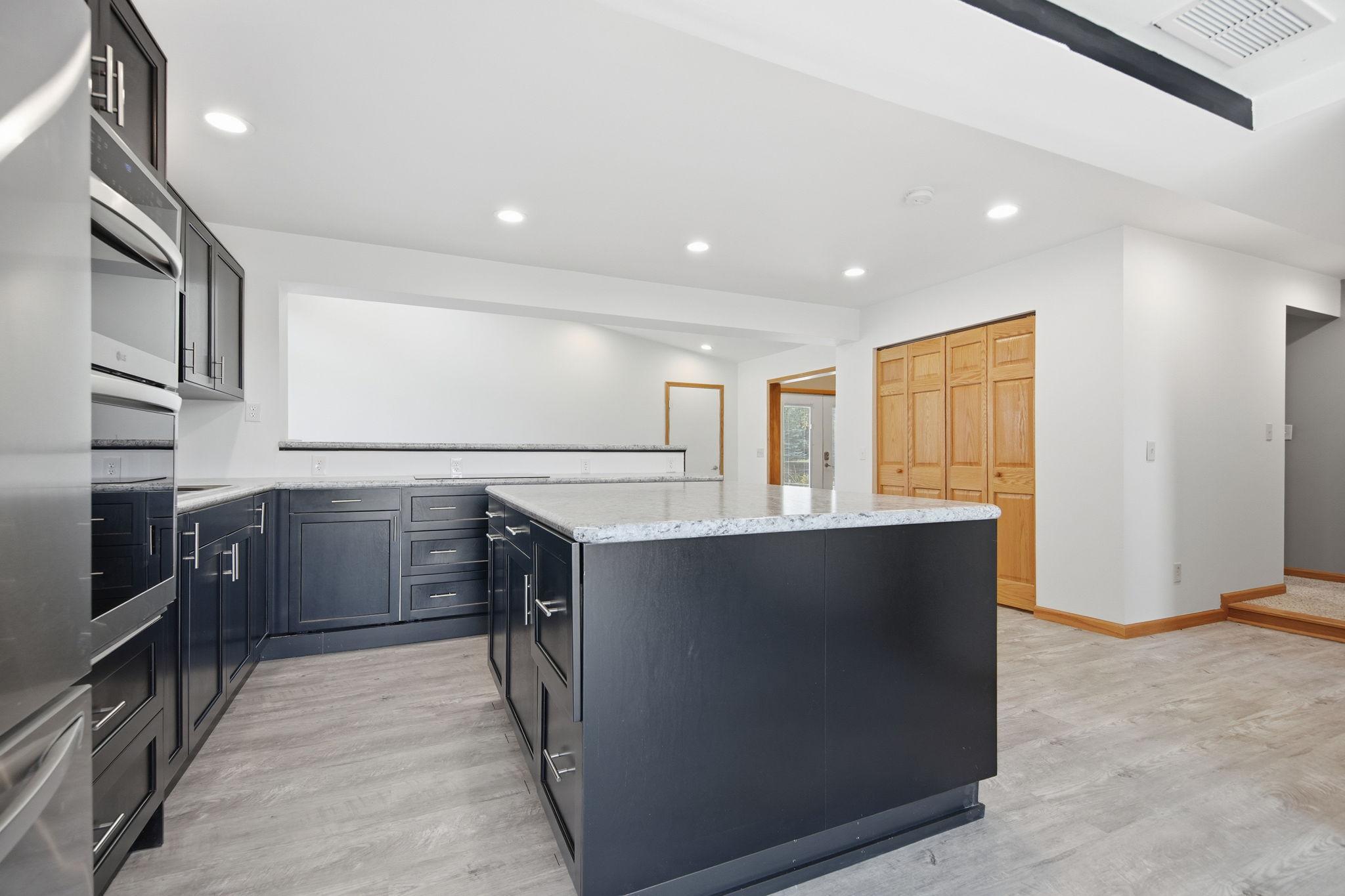 Behind the six panel doors is a spacious pantry area.