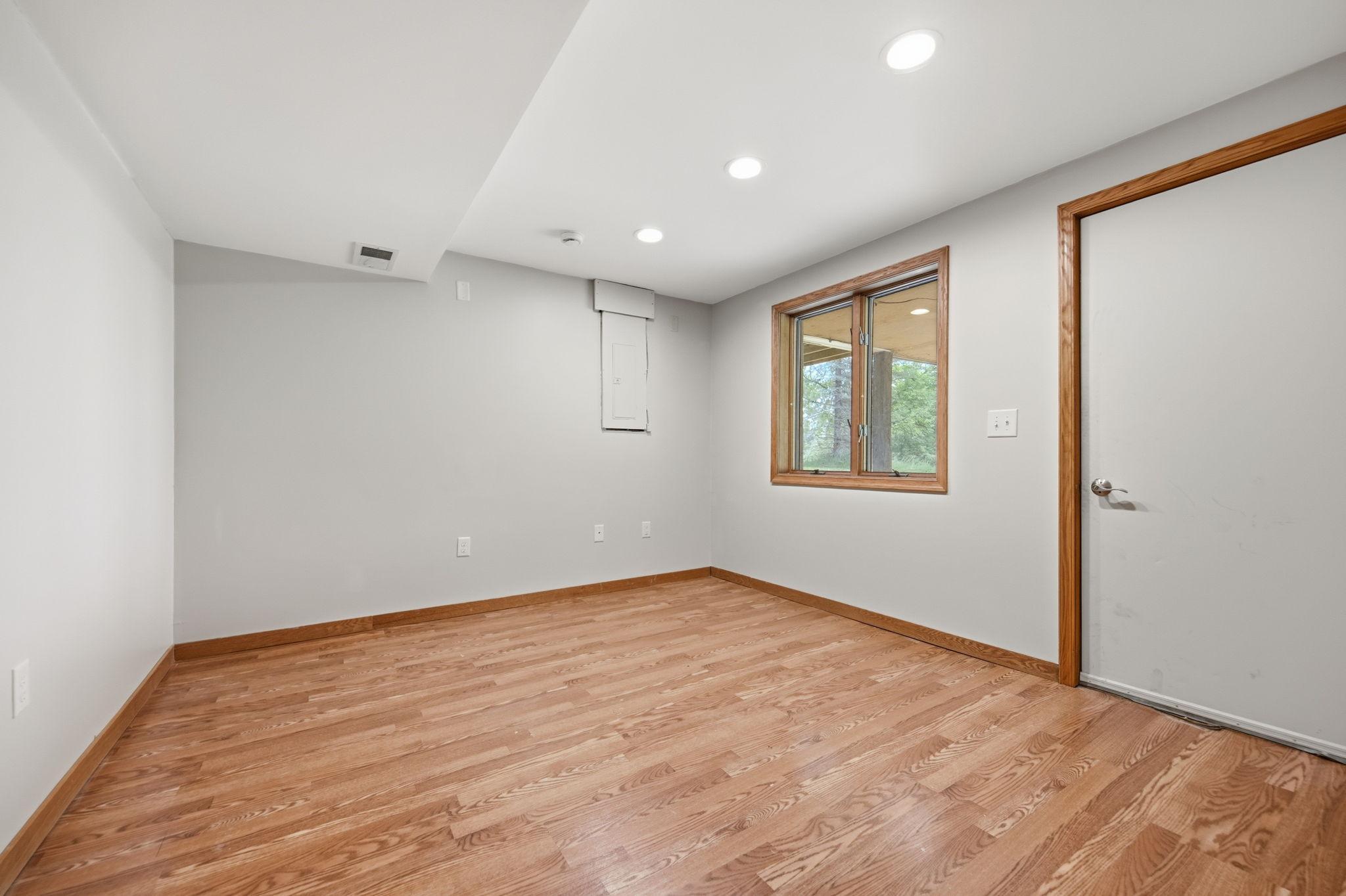 The fifth bedroom was most recently used as a home office. The door leads to a covered area below the upper-level porch.