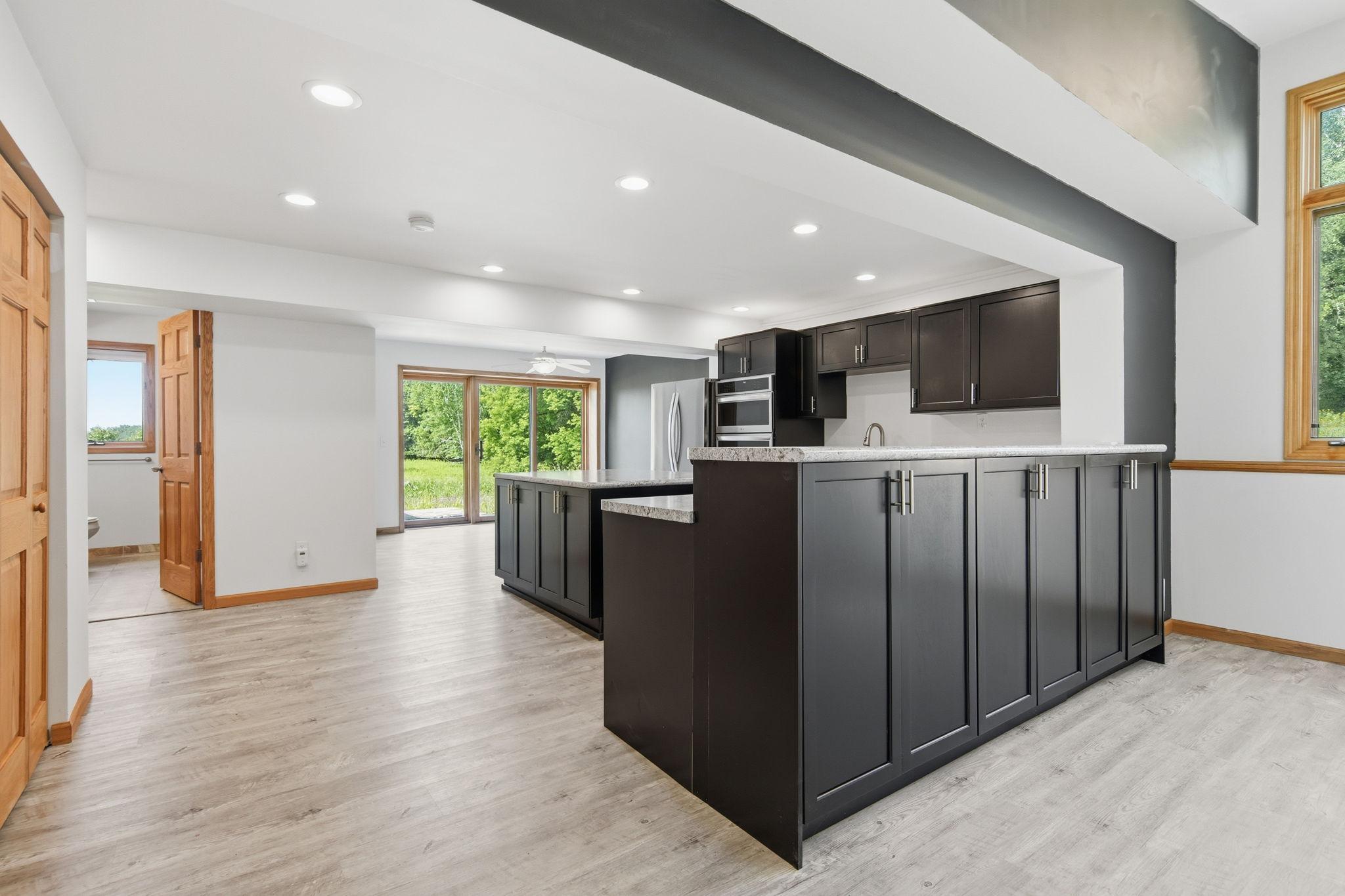 The tall cabinet room divider features spacious storage options.