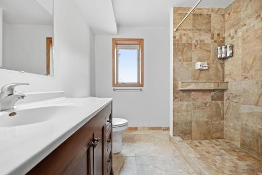 The shower is oversized, and you'll love the natural daylight window overlooking the backyard. Note: the laundry/utility room is directly adjacent to this bathroom.