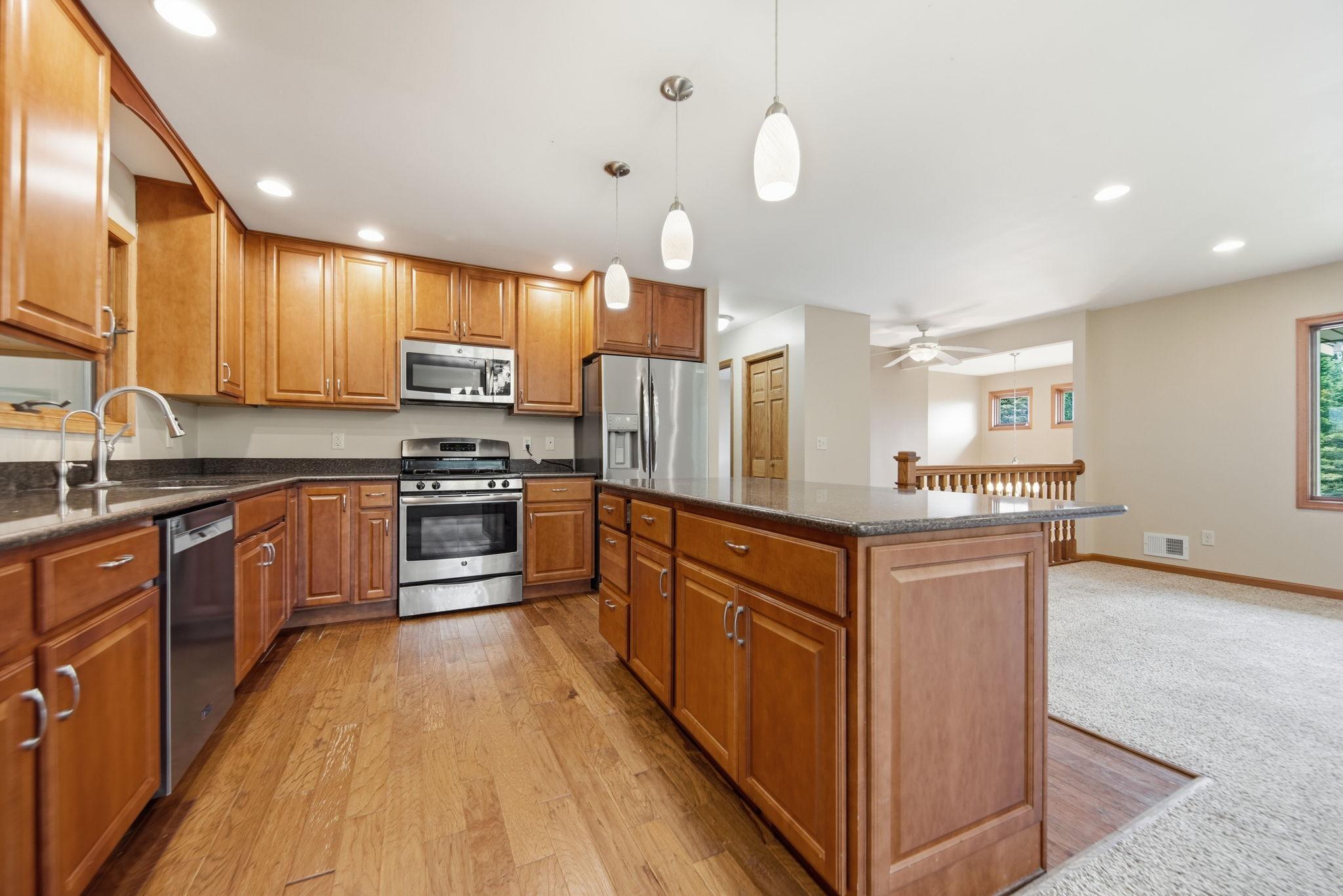 The kitchen features nice stainless steel appliances, including a new dishwasher.