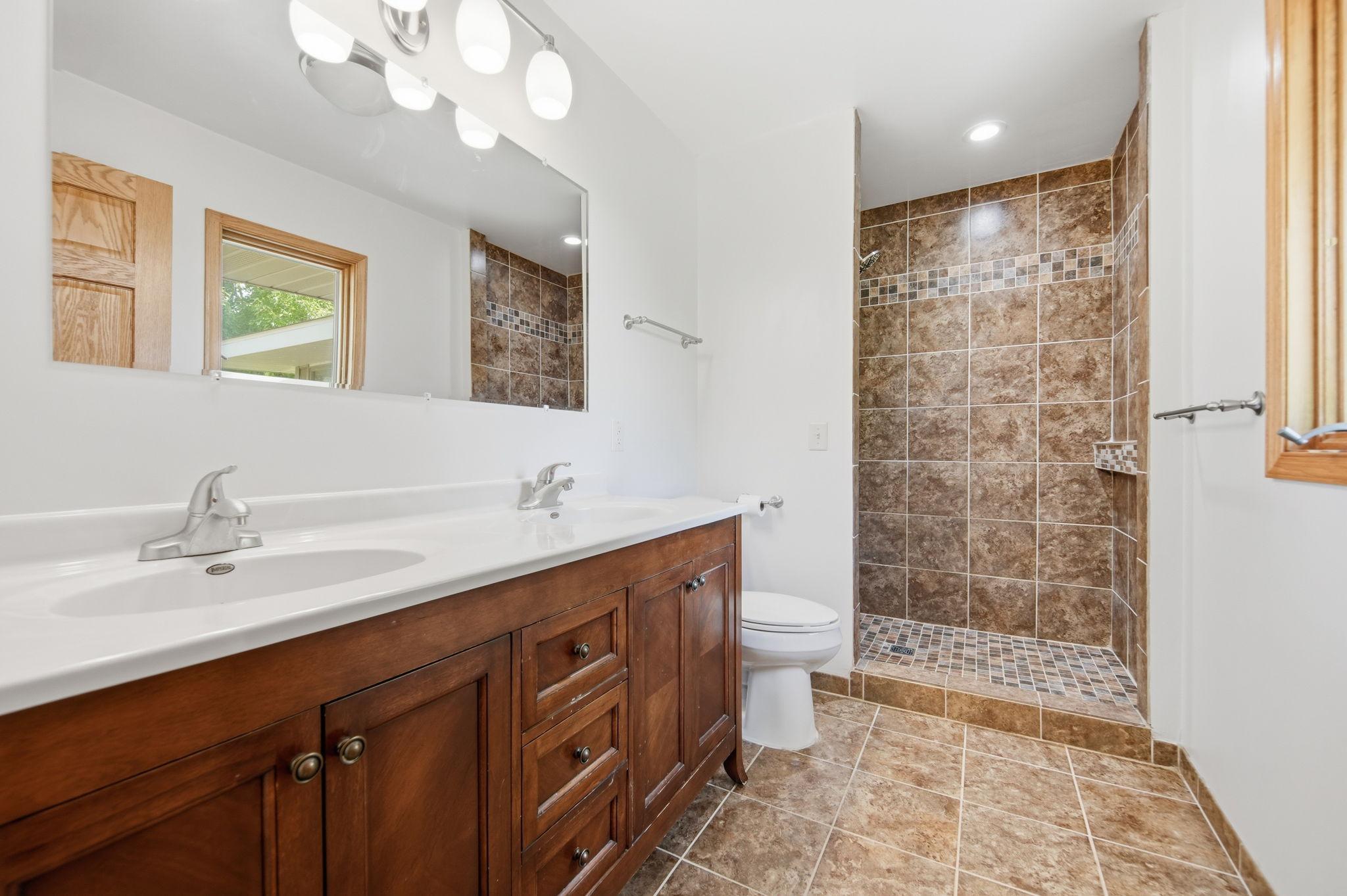 You'll love the owner's bath area features: dual sinks, tiled floors and a custom tile shower. You'll also enjoy the natural daylight window overlooking your backyard.