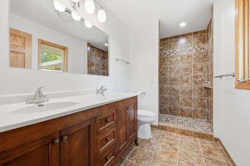 You'll love the owner's bath area features: dual sinks, tiled floors and a custom tile shower. You'll also enjoy the natural daylight window overlooking your backyard.