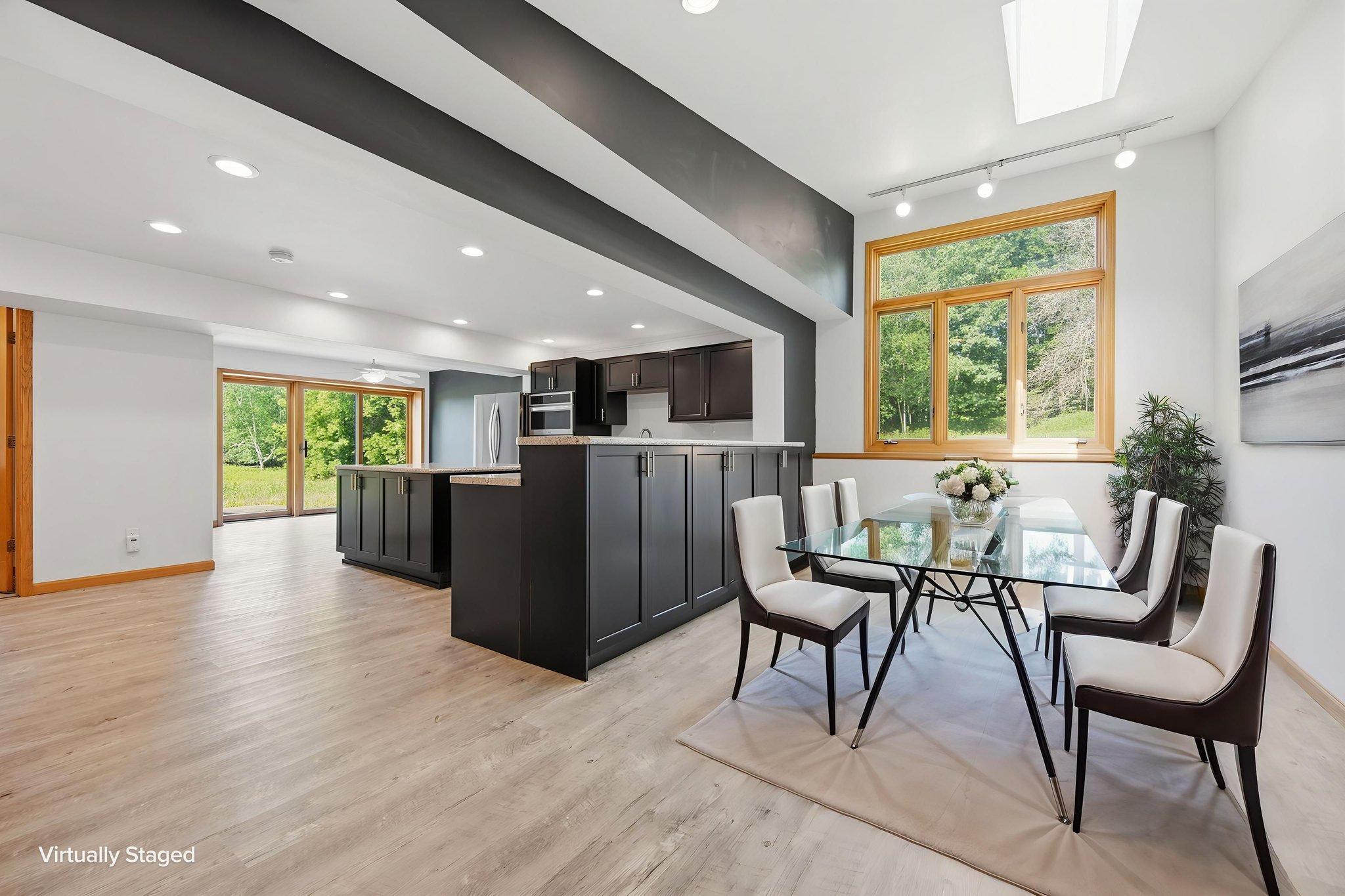 Virtually Staged Note: this area could easily adapt to be a family room space and a dining area could be utilized on the other end of the room (where the sliding glass doors are located).