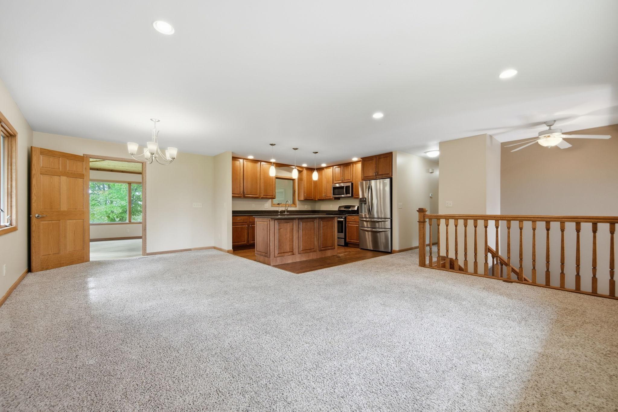 In this view from the corner of the living room, you can get a good idea of how the layout works. The open six panel door on the other side of the dining room leads to the four season porch.