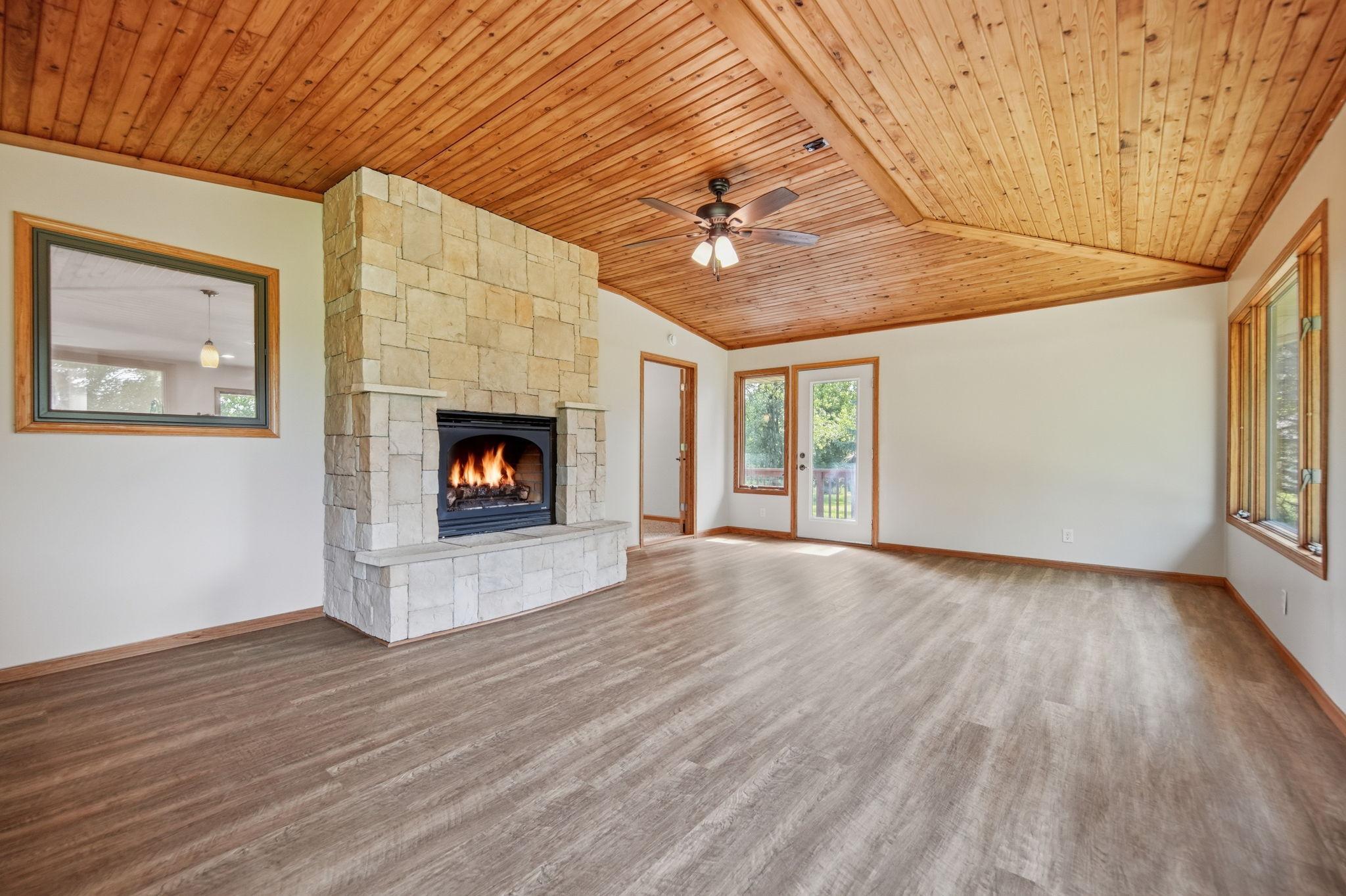 You'll love the easy care floors and the knotty pine ceiling. The clearview glass door leads to the deck area.
