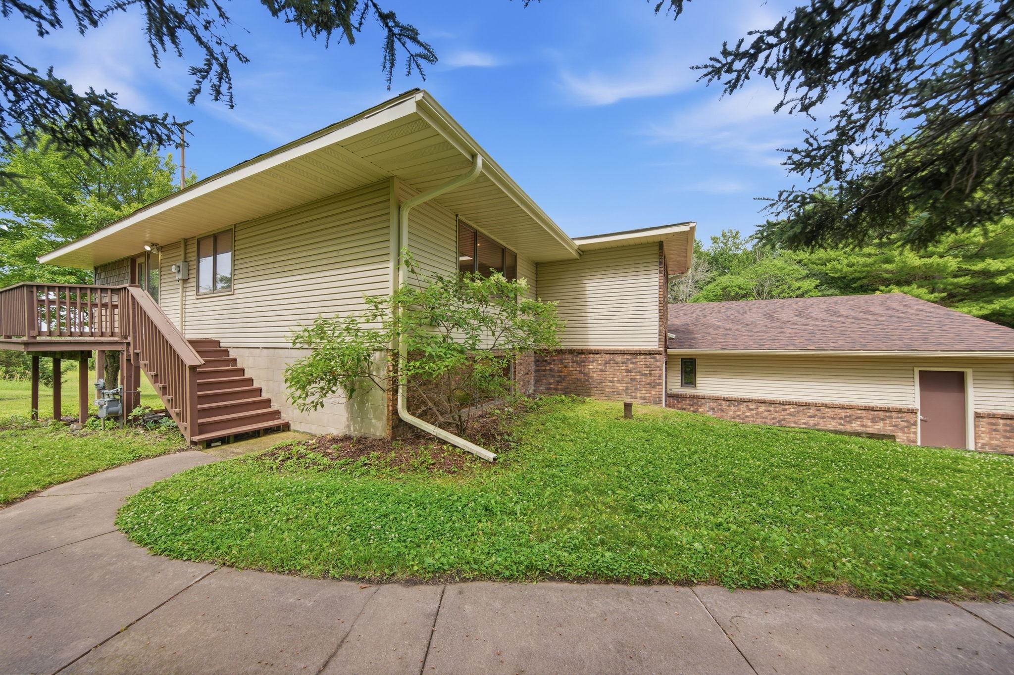 This home features a new deck... The siding was recently refreshed with a few new gutters and shakes on the four season porch to complement the aluminum and brick siding.