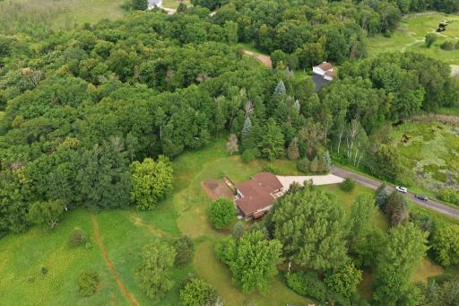 The property line follows the lighter green mown grass areas into the woods at the top of the photo in this shot.