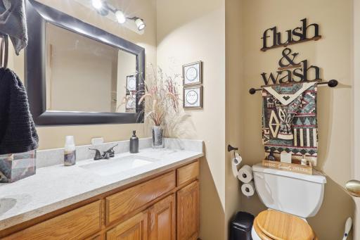 Main Floor Half Bath and counter tops match kitchen counter tops that are granite.