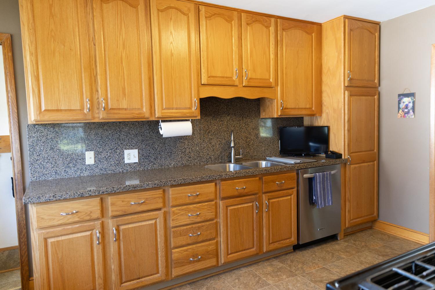 2nd view of Kitchen featuring abundant cabinetry and solid-surface countertops/backsplash