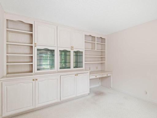 Main floor den with built in cabinetry for office / sitting area.