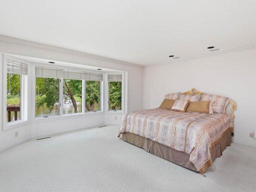Main floor bedroom has with serene pond views.