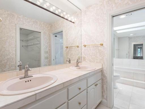Main floor primary bedroom bath with double sinks and ample counter space.