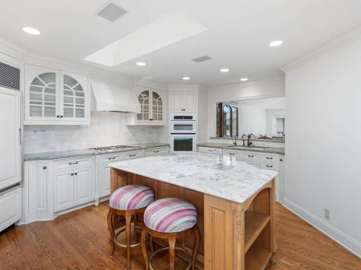 Center island gourmet kitchen. Exquisite design with views to vaulted dining / living room.