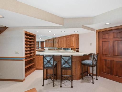 Bar area with wine rack, beverage fridge, dishwasher and sink.