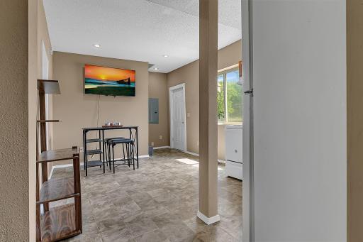 From the dining room/family room back toward the right front entry. Flat screen, wall mounted TV conveys with the home.