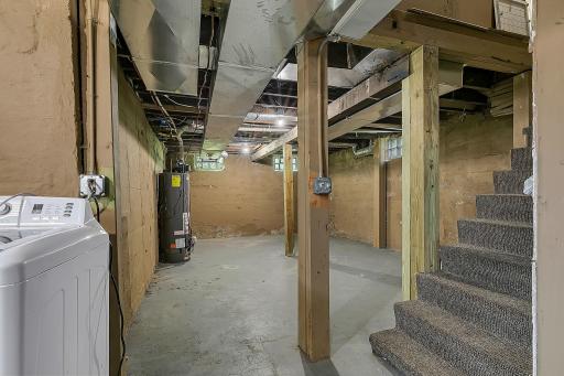 Another shot of the unfinished basement. Earlier this year, two new support beams were added to address some main level floor sloping. The floor has settled as far as it can!