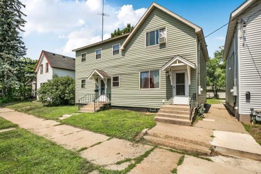 Looks like a duplex with two front entry options, but single family all the way. Lockbox is located on the right hand door. Not much grass to mow, but adequate for your dogs. The vinyl siding has some cosmetic warping but is low maintenance.