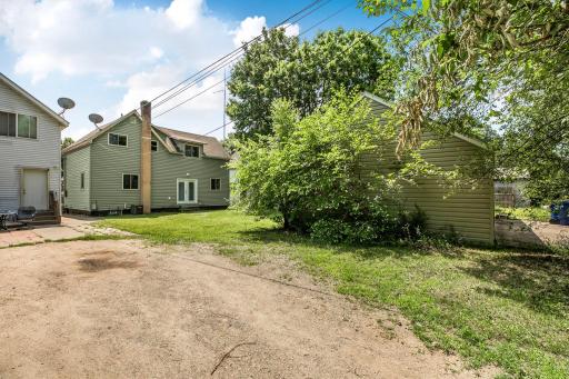 Back yard side view. Garage is hiding behind overgrown bush on the right.