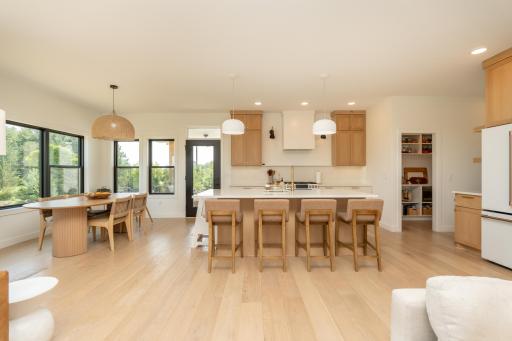 Stunning chef's kitchen with oversized quartz island and walk-in pantry