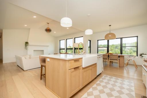 Open-concept kitchen, dining, and living spaces all filled with natural light.