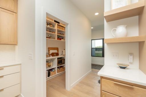 Large walk-in pantry with built-in shelving and abundant storage