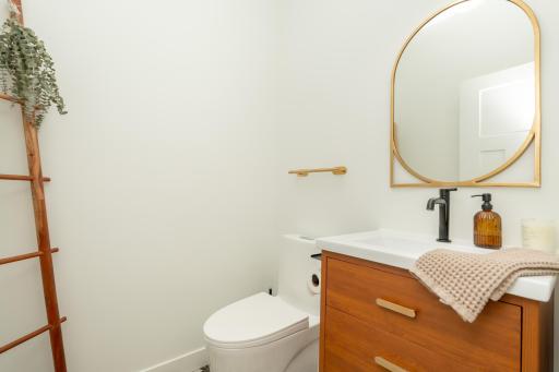 Stylish main-level powder room with custom vanity and designer fixtures