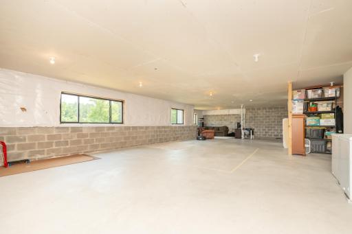 Expansive unfinished lower level offering endless possibilities for a future bedroom, a family room, home gym, or entertainment space
