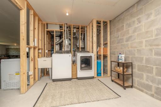 Lower-level laundry and mechanical area with additional storage space