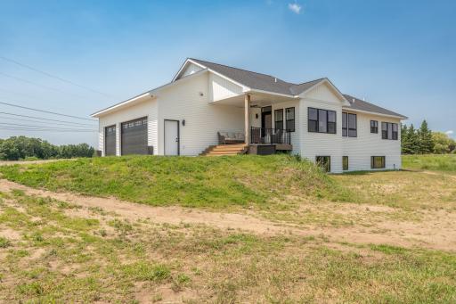 Beautiful rear elevation showcasing the lower level and spacious backyard