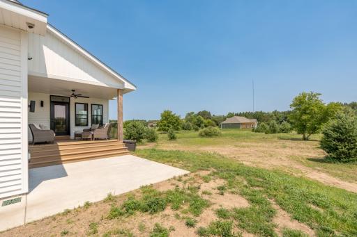 Concrete patio below the covered deck provides additional outdoor living space