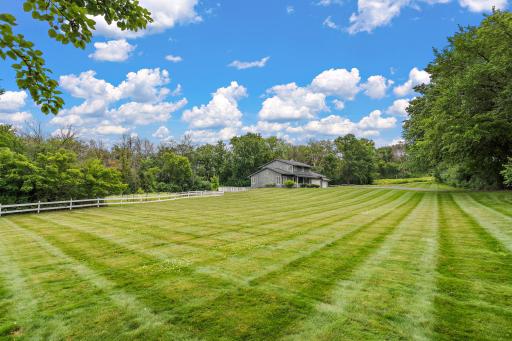 Woods surround the lot and lovely yard surround the home with plenty of sunshine for gardens, game & play area for family and friends.