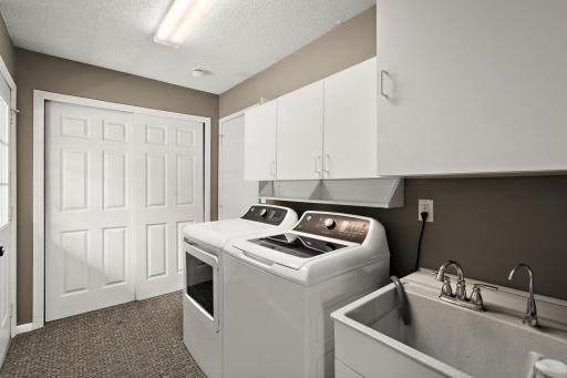 Main floor laundry with new washer and dryer in 2025.