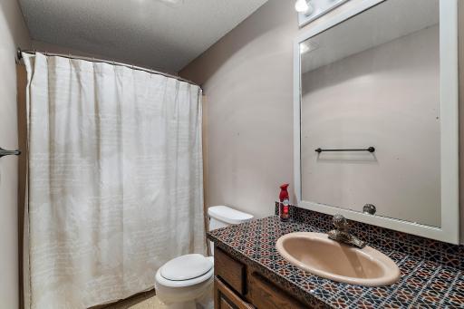 Second full bath serves two other bedrooms .