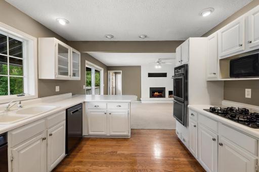 Kitchen with oak hardwood floor, several newer appliances, updated cabinets convenient to main floor family room.