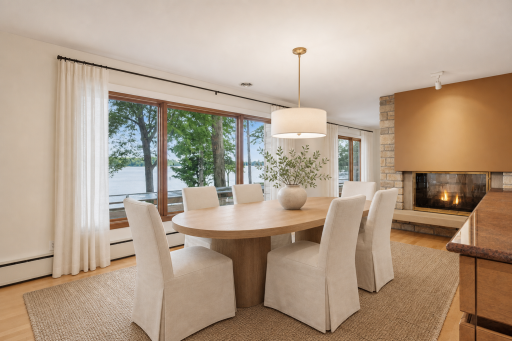 Formal Dining with fireplace and stunning lake views. Virtually staged