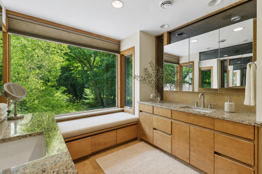 Primary Bathroom with double sinks and large picturesque window.