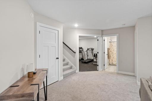Stairs to upper level. French door into the current workout area.