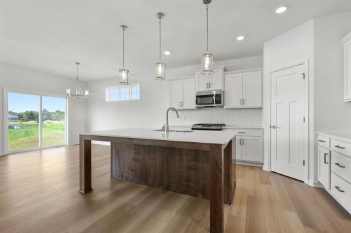 Kitchen and dining area. Photo is a completed home for illustrative purposes. Personalize this home with your chosen finishes.
