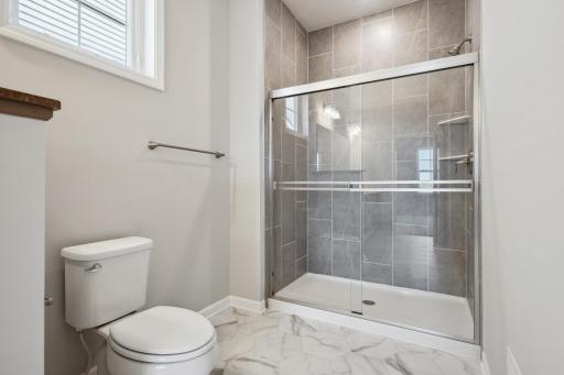 Owner's bathroom. This option shows a tiled shower. Photo is a completed home for illustrative purposes. Personalize this home with your chosen finishes.