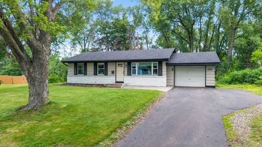 This home has an attached garage, spacious driveway and front patio