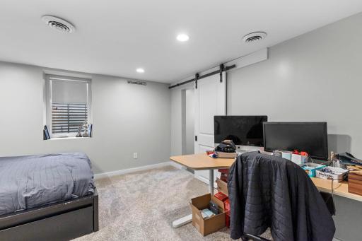 Lower level bedroom includes and ensuite bath through barn door